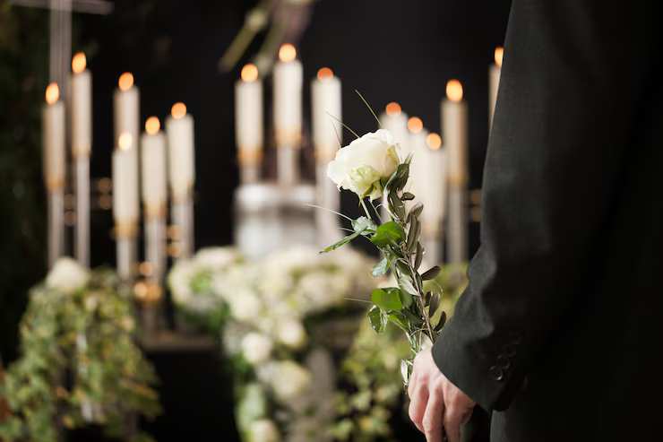 woman-holding-white-flower-funeral